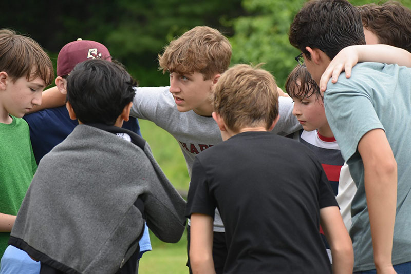 Boys in a huddle outside