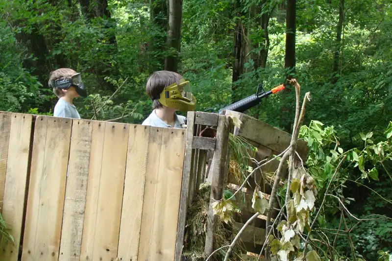 boys outside playing airsoft