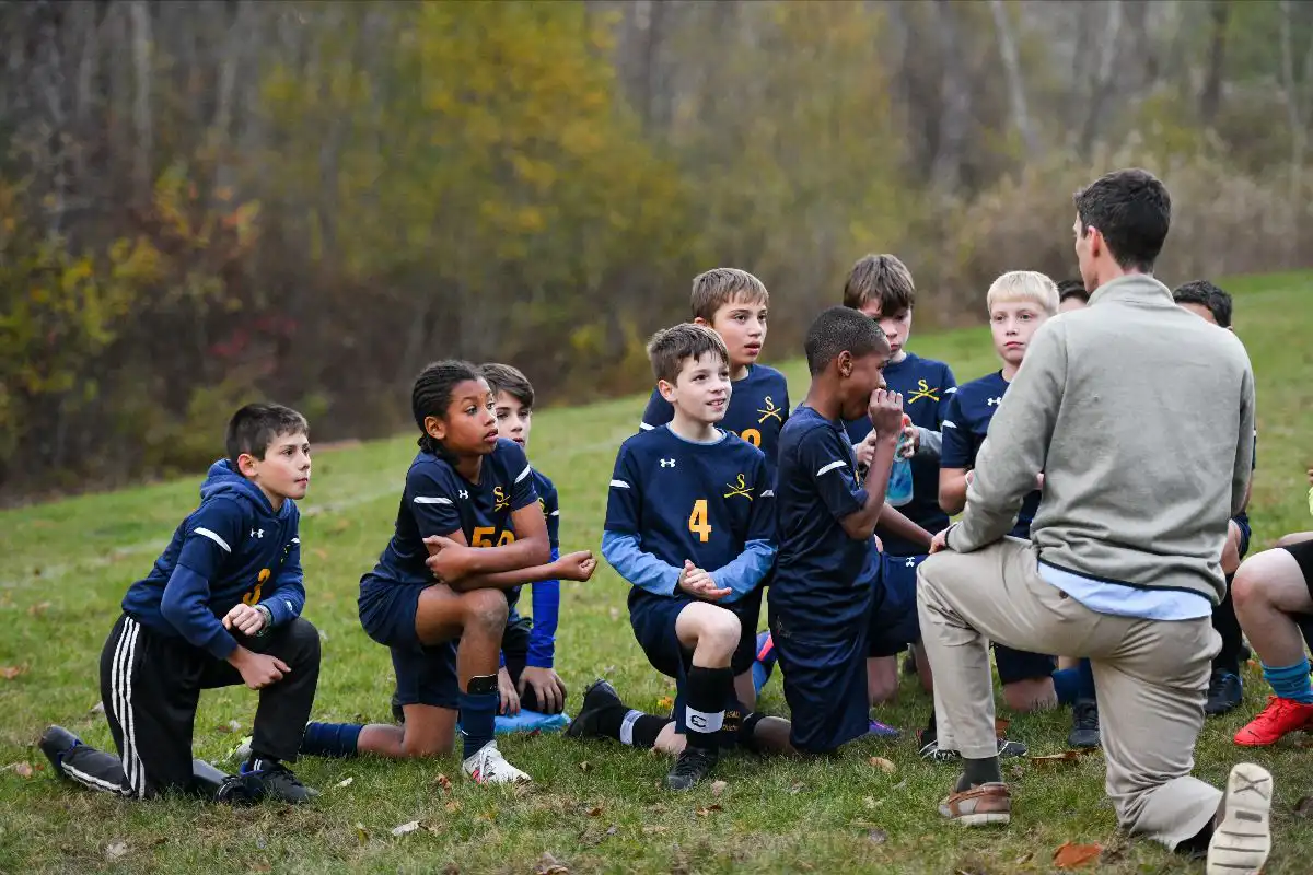 Team of boys listening to coach