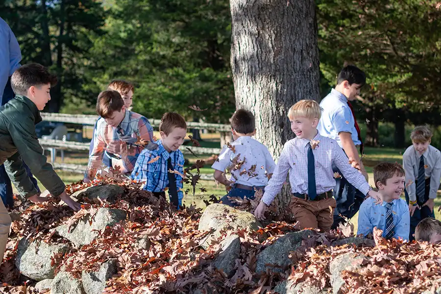 Boys school outside with leaves