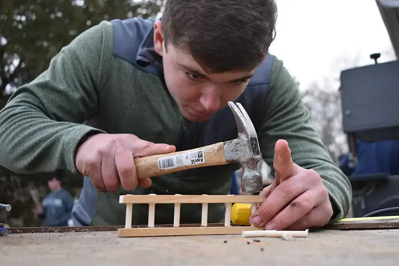 Male student hammering