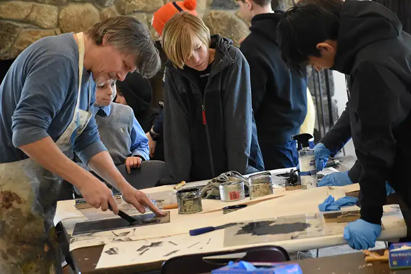 High School Male learning a trade