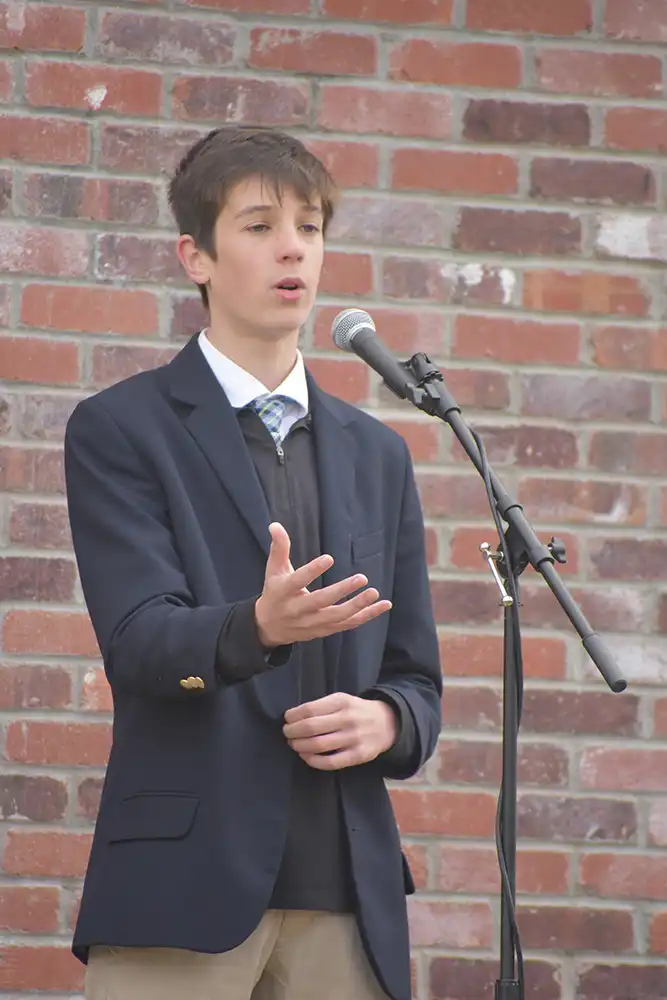 Male student speaking with mic