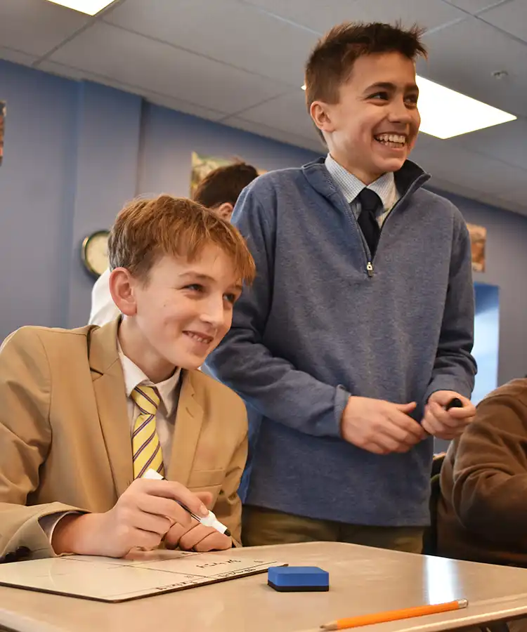 Two boys in class smiling