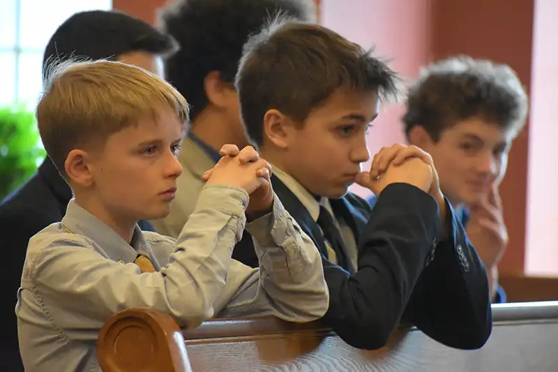 boys praying in chapel