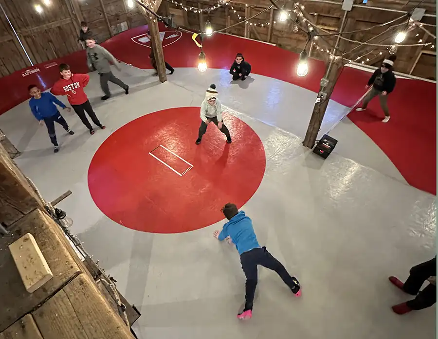 sparhawks-wrestling Male student sitting by fireplace reading Beowulf