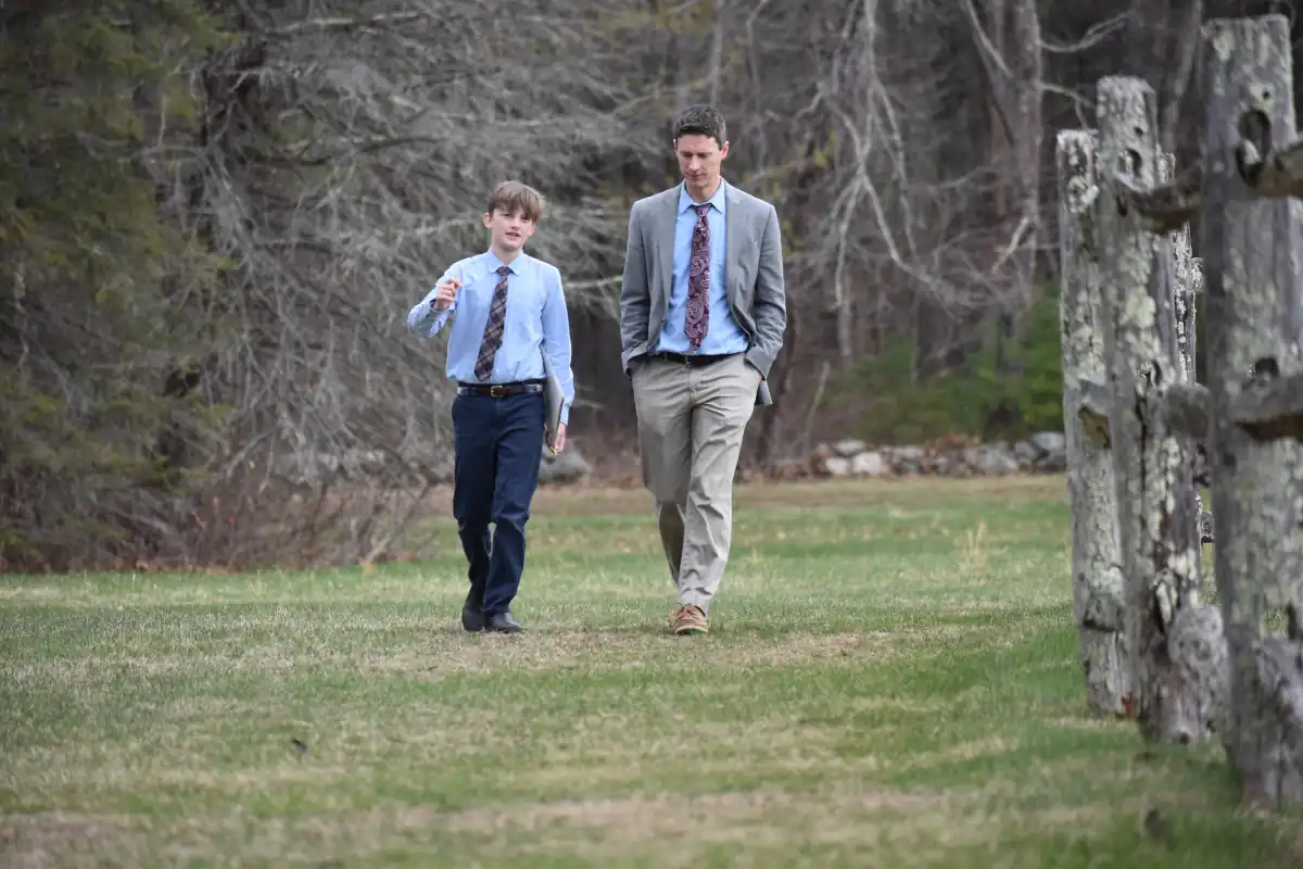 A teacher mentors a student on the Sparhawk grounds