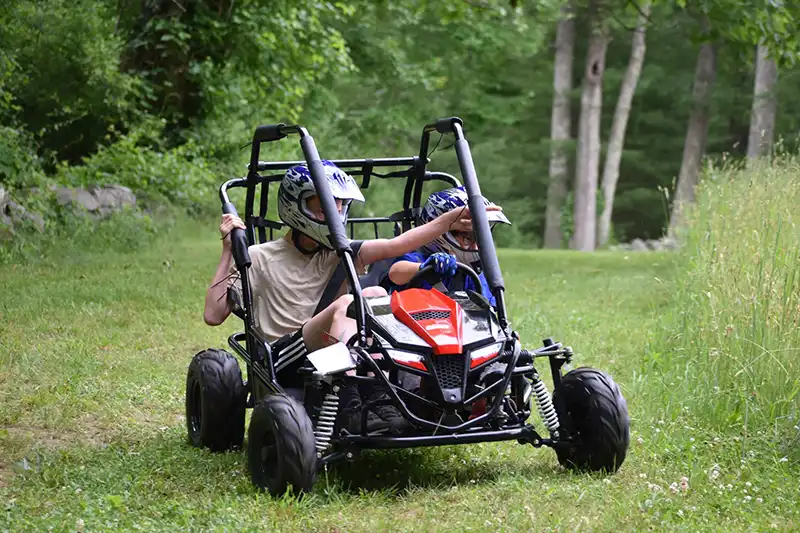 Boy riding go kart at camp, Millis, MA