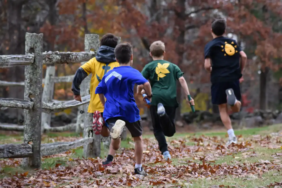 School boys running outside in the fall