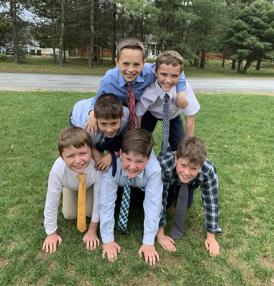 Boys making a pyramid in dress clothes